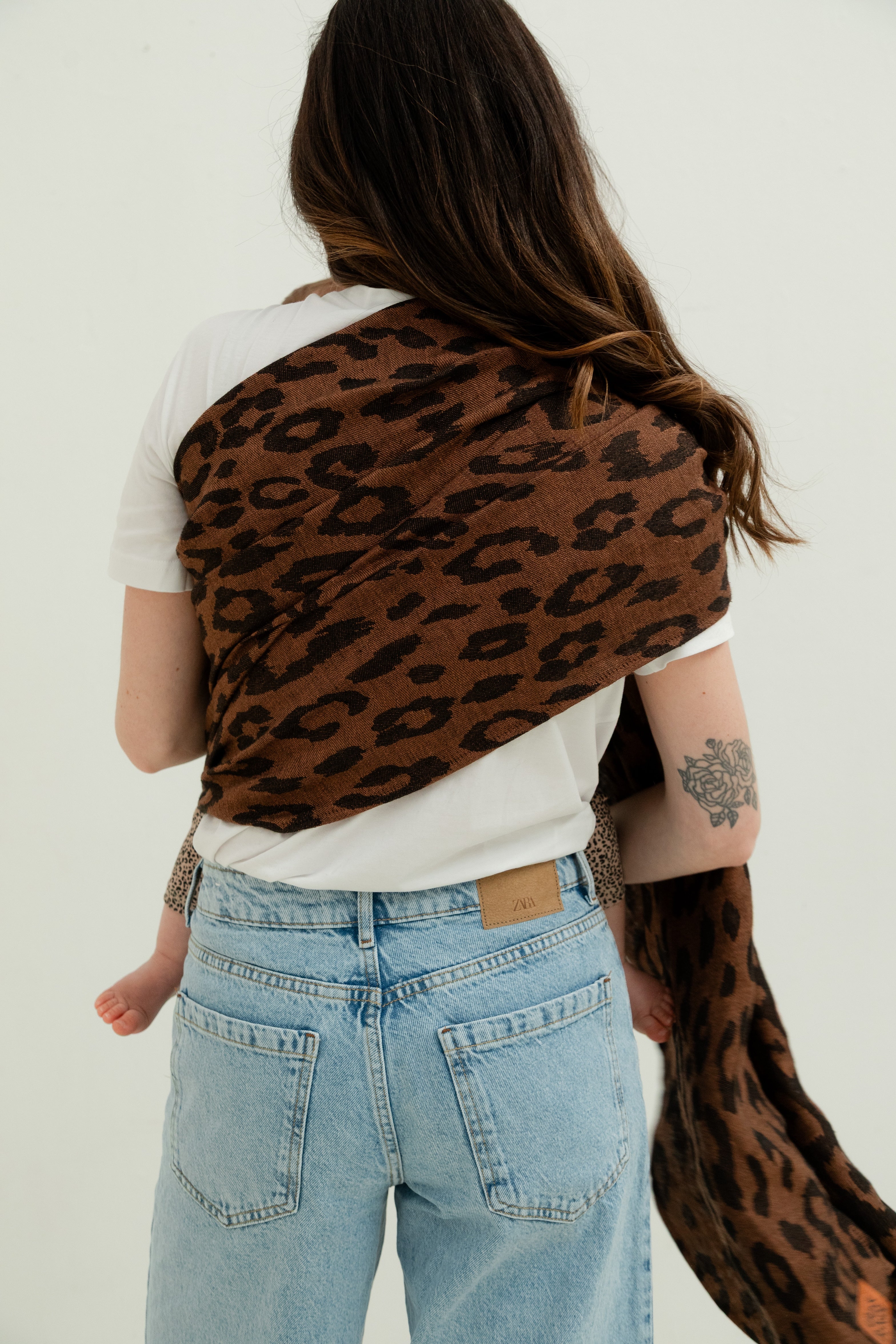 Bébé porté en ring sling en lin motif léopard, léger et respirant, vu du dos